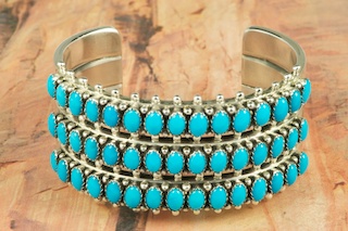45 Genuine Sleeping Beauty Turquoise Stones set in heavy gauge Sterling Silver Bracelet. Created by Navajo Artist Paul Livingston. Signed by the Artist.